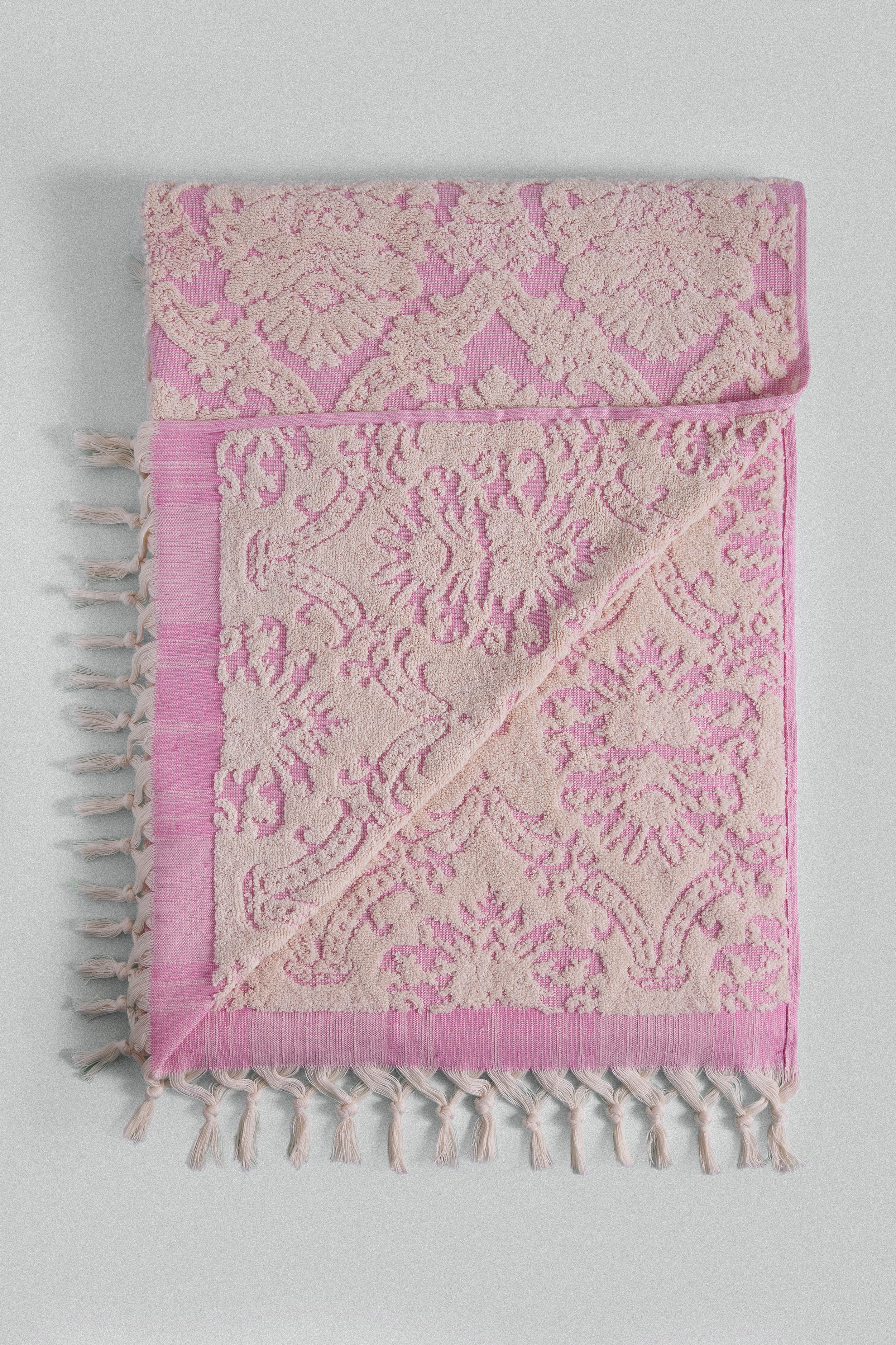 Carnation jacquard Turkish cotton bath towel in pink inspired by Ottoman floral motifs.