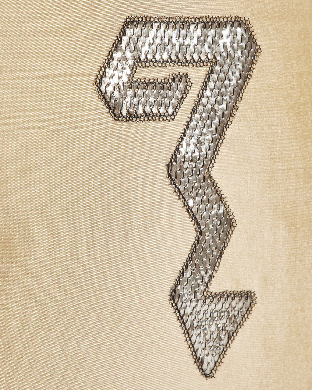Close-up of silver metallic serpent embroidery on pale yellow Indian dupion silk cushion